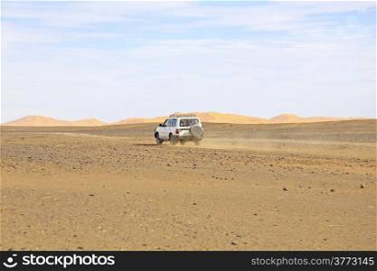Car driving in the Erg Chebbi desert in Morocco Africa