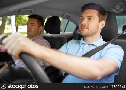 car driving lesson and carpooling concept - instructor on passenger seat and young driver. car driving school instructor and male driver