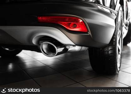 car exhaust pipe. details of stylish car interior, leather interior. Exhaust pipe of a luxury car. Tailpipe chromed made of stainless steel on powerful sport car bumper. Close up. car exhaust pipe. Exhaust pipe of a luxury car. details of stylish car interior, leather interior. Close up