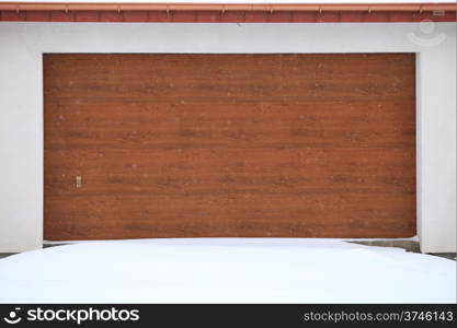 car garage door surrounded by snow, winter time