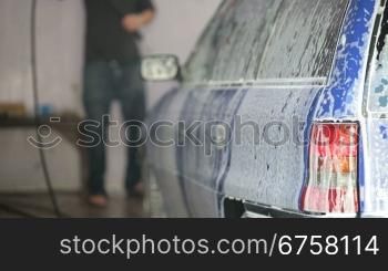 car in soap foam at carwash