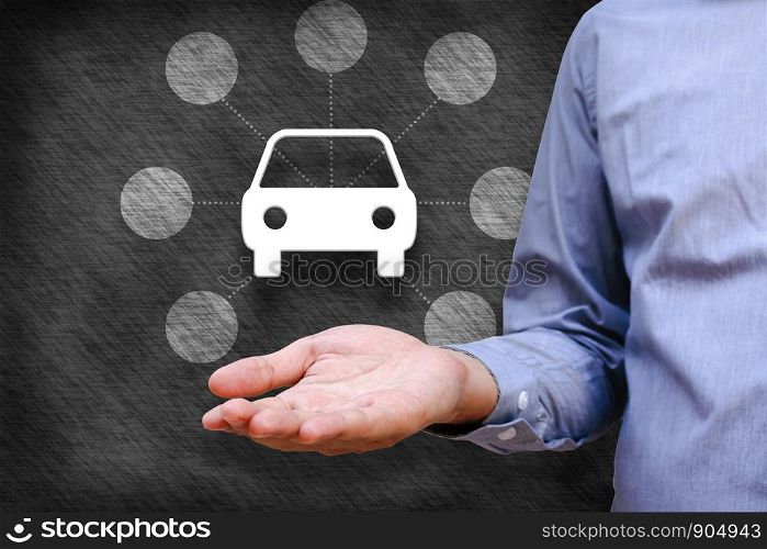 Car insurance and car services concept. Businessman holding icon of car and link copt space.
