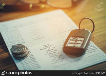 Car insurance,Car remote and account book in finance and banking concept