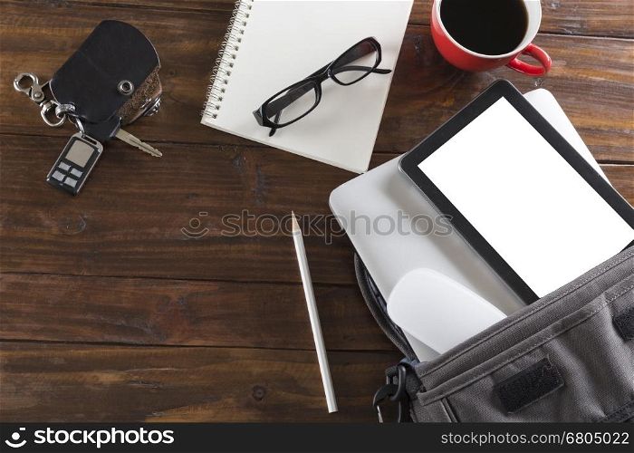 car key, laptop computer and tablet on wooden office desk - top view