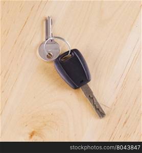 Car key over wooden table, square image