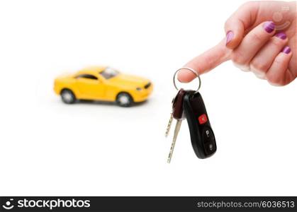 Car keys and car at background isolated on white