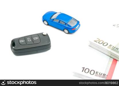 car keys, blue car and euro notes on white