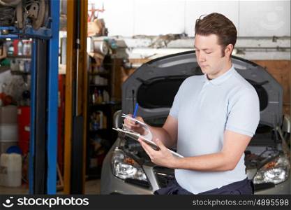 Car Mechanic Working In Auto Repair Shop