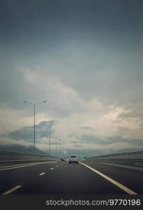 Car moving on the highway in front of a big mountain