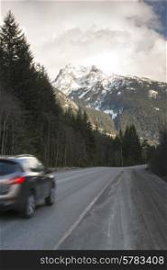 Car moving on the road through mountains, Whistler, British Columbia, Canada