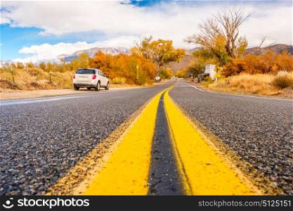 Car on highway shoulder at autumn. California, USA.