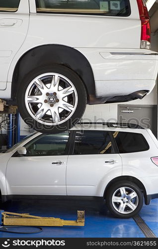 Car on hoist in automobile repair shop