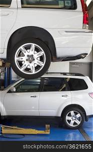 Car on hoist in automobile repair shop