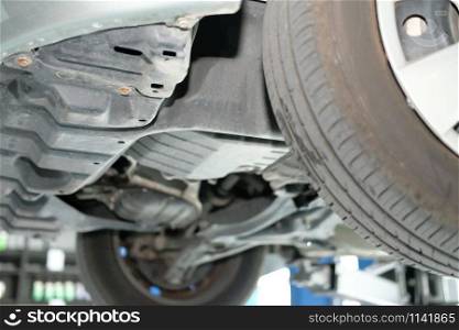 car on lift in automobile repair service garage
