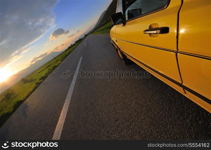 car on the road at beautiful sunset
