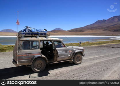 Car on the road near the salt lake near Uyuni in Bolivia