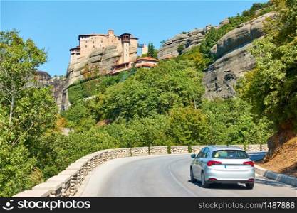 Car on the road to The Monastery of Rousanou in Meteora, Greece