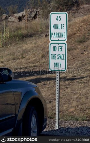 car parked at no fee short term space at trailhead in mountain park