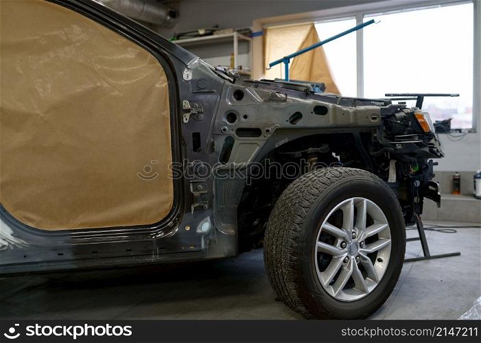 Car prepared for painting in auto body shop. Cropped shot. Automotive industry or repair service. Car prepared for painting in body shop