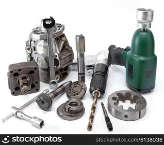 Car repair - details of the pump of high pressure, air impact wrench, air drill on white background