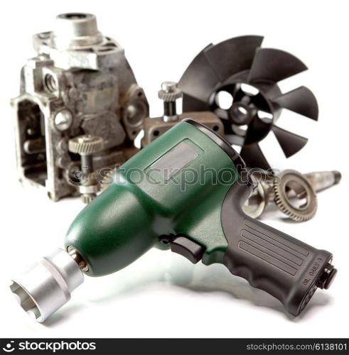 Car repair - details of the pump of high pressure and air impact wrench on white background