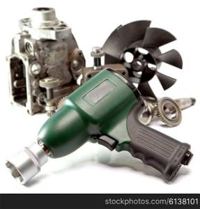 Car repair - details of the pump of high pressure and air impact wrench on white background