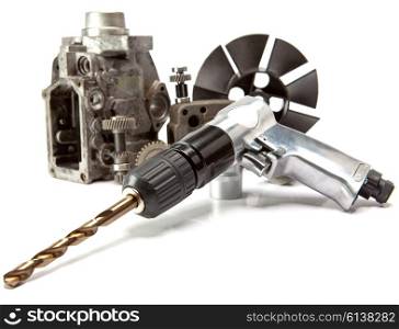 Car repair - details of the pump of high pressure and air drill on white background
