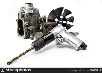Car repair - details of the pump of high pressure and air drill on white background