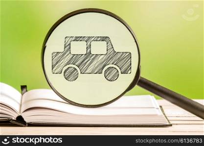 Car search with a pencil drawing of an automobile in a magnifying glass
