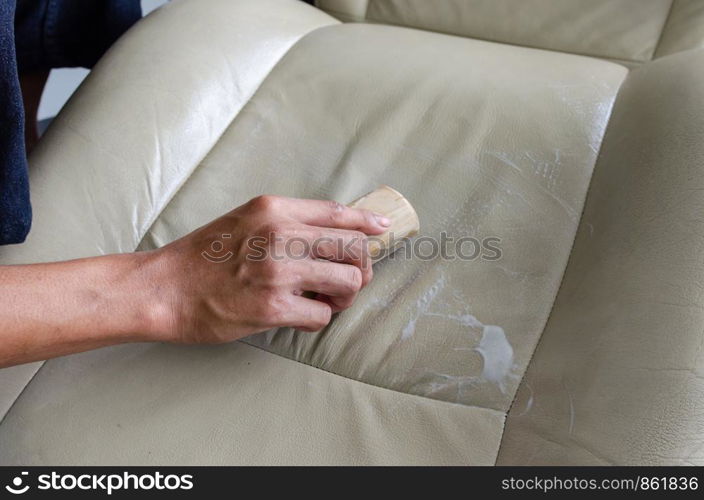 Car seat upholstery cleaning with brushes and chemicals.