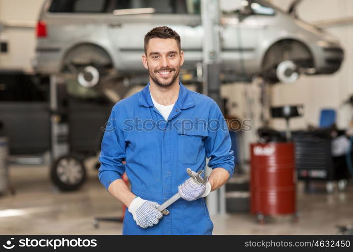 car service, repair, maintenance and people concept - auto mechanic man or smith with wrench at workshop