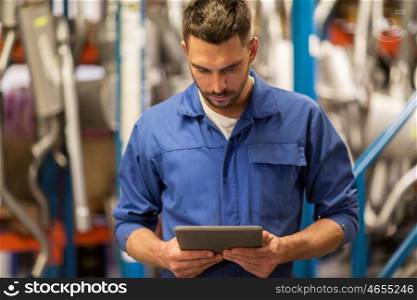 car service, repair, maintenance and people concept - auto mechanic man or smith with tablet pc computer at workshop or warehouse