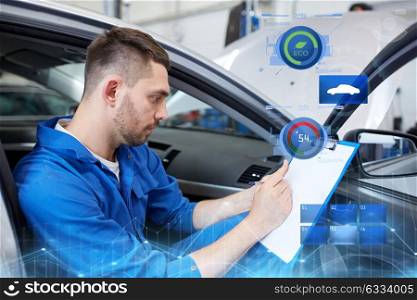 car service, repair, maintenance and people concept - auto mechanic man or smith with clipboard writing at workshop. auto mechanic man with clipboard at car workshop