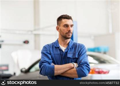 car service, repair, maintenance and people concept - auto mechanic man or smith at workshop