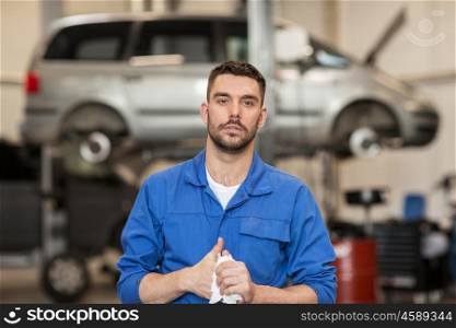 car service, repair, maintenance and people concept - auto mechanic man or smith at workshop
