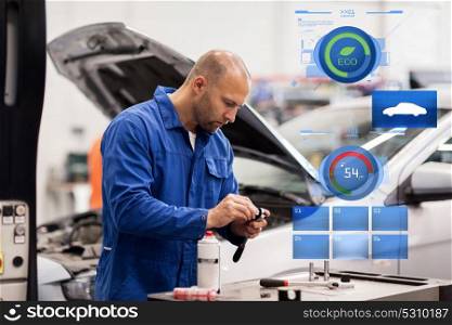 car service, repair, maintenance and people concept - auto mechanic man with wrench and lamp working at workshop. mechanic man with wrench repairing car at workshop