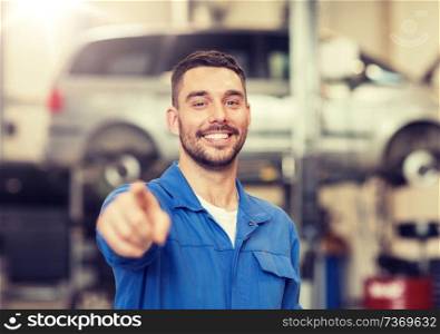 car service, repair, maintenance and people concept - happy smiling auto mechanic man or smith at workshop. happy auto mechanic man or smith at car workshop