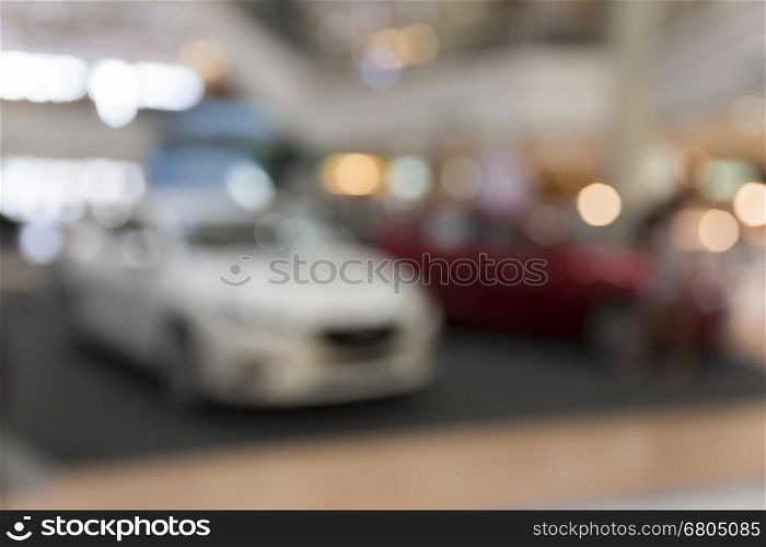 car showing in showroom for sale, blur background with bokeh light
