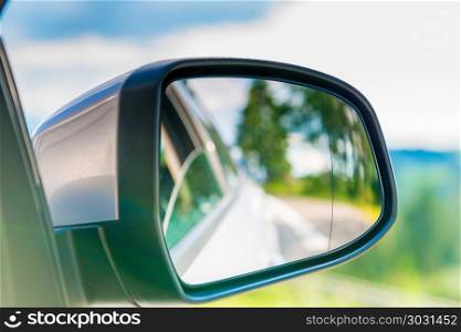car side mirror with a reflection of the beautiful scenery in it. car side mirror with a reflection of the beautiful scenery in it, close-up