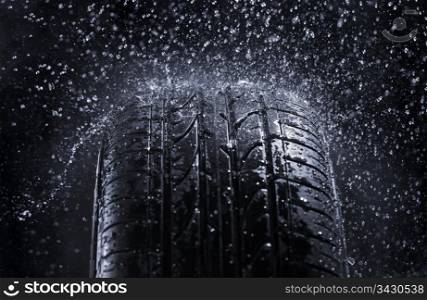 Car tire in rain.