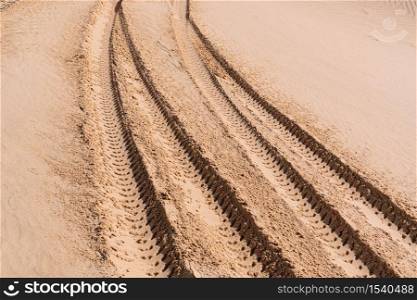 Car tire marks in the sand. Car tracks on desert.