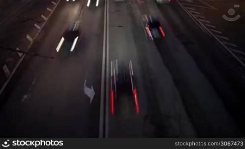 Car traffic at night. Time lapse with panning. High angle shot with long exposure shot with motion blur.