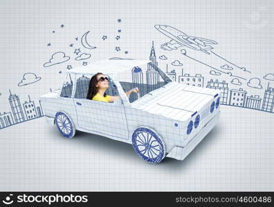 Car traveling. Young woman riding car made of list of paper