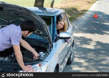 Car troubles couple starting cables broken vehicle on the road