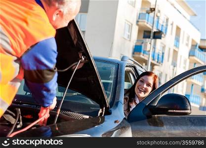 Car troubles woman starting cables broken vehicle on the road