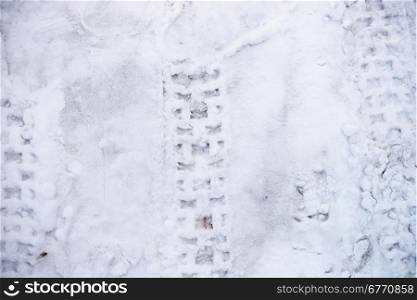 Car tyre track in white snow