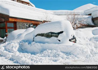 Car under heavy snow in winter