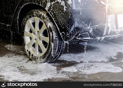 Car wash black with foam bubbles