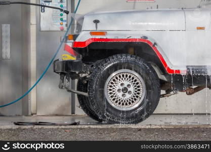 car wash with a jet of water and shampoo