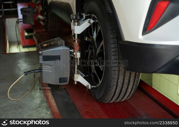 car wheel alignment in progress at auto repair service station